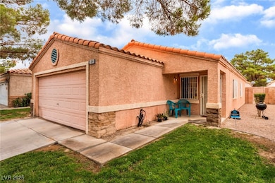 View of front facade with a garage, a tile roof, s