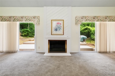 Unfurnished living room featuring carpet floors