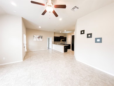 Family room with tile floor and ceiling fan