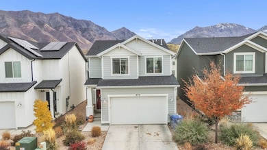View of front facade featuring a mountain view, driveway, an attached garage, and a shingled roof
