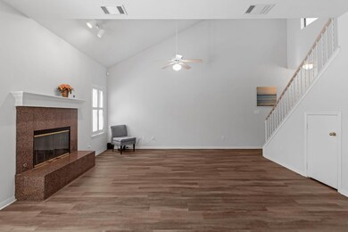 Living area with stairs, visible vents, a ceiling
