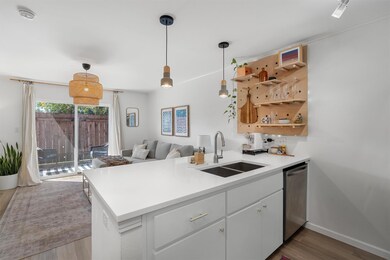 Kitchen featuring hanging light fixtures, stainle