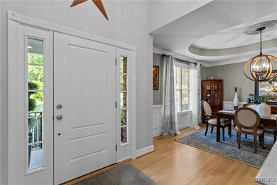 Foyer featuring a chandelier, light wood-style flo