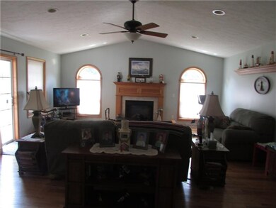 Family room with vaulted ceiling & gas fireplace.