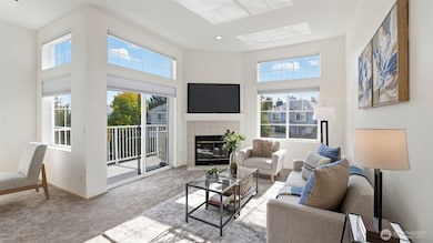 Sunlight streams through walls of windows, creating a warm and welcoming living space.