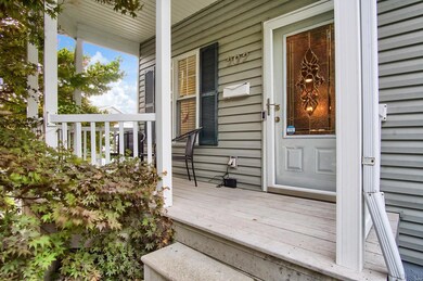 Front porch with room for chairs and a small table. The composite decking gives you more time to enjoy and less maintenance.