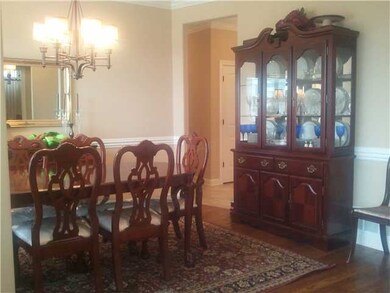 Formal Dining Room has custom moldings and hardwoo