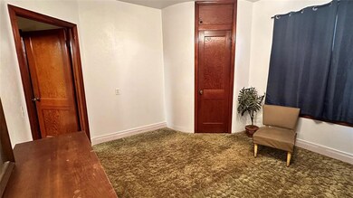 Living area featuring dark colored carpet