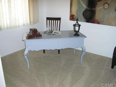 This corner of the den works perfectly for a desk,