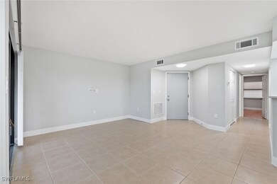 Spare room with light tile patterned floors and ba