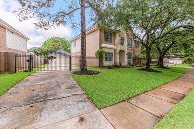 A expansive driveway leads up to a detached garage!  The custom iron gate adds extra security and privacy!