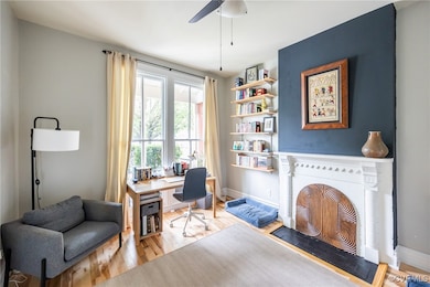 Multi-purpose room, wood floors, ceiling fan, fire