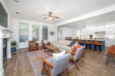 Living room featuring crown molding, ceiling fan, 