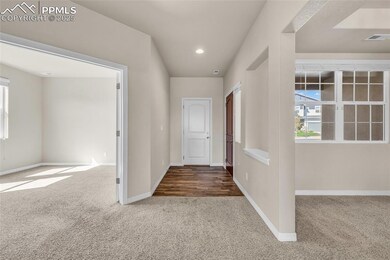 Hall featuring carpet, plenty of natural light, and recessed lighting