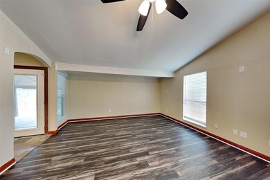 Empty room featuring lofted ceiling, wood-type flo