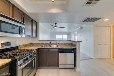 Kitchen featuring stainless steel appliances, a si