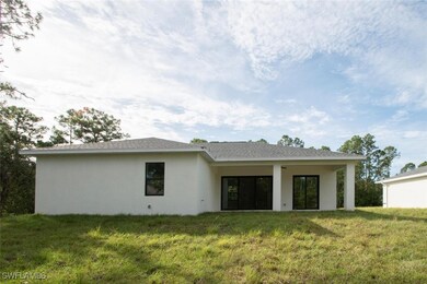 Rear view of house with a lawn