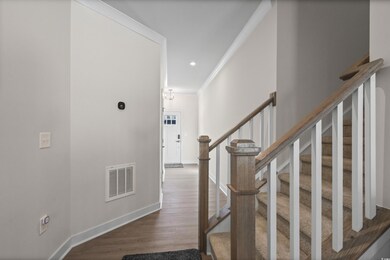 Stairs featuring hardwood / wood-style flooring an