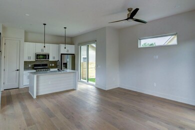 Kitchen with white cabinets, a sink, stainless st