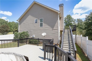 Deck with stairway and a fenced backyard