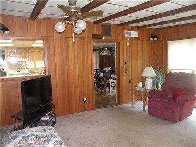 Family Room. The rustic wood paneled family room i