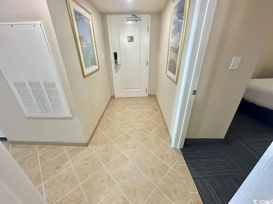 Hall featuring baseboards and tile patterned floors