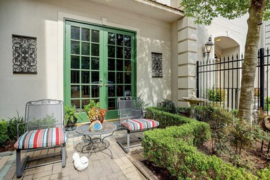 French doors lead to an inviting front courtyard w