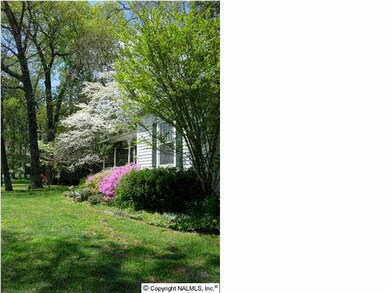 Beautiful landscaping with flowering trees and shrubs at the front of the home welcome the spring season.