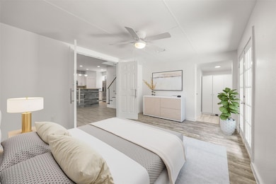 Bedroom with light wood-style flooring, multiple 