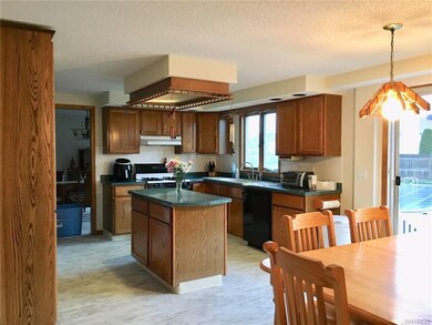 Nice Oak Cabinets in sunny kitchen with center isl