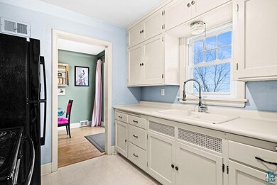 Kitchen featuring light countertops, light floors,