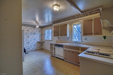 Large eat-in kitchen with built-in appliances.