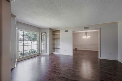 Empty room with a textured ceiling, a chandelier, 