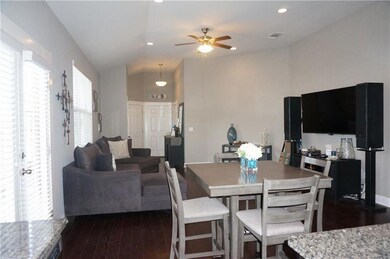 Dining space featuring a ceiling fan, dark wood-t