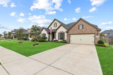 A double-wide driveway with dual sconce lighting leads to the 3-car oversized and tandem garage, complete with a Chamberlin garage door opener, for plenty of convenient parking.