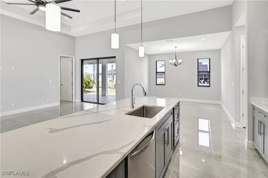 Kitchen featuring light stone counters, dishwasher