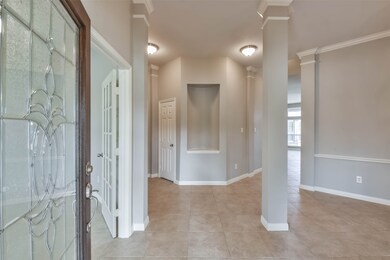 The entryway to this home is just beautiful! The foyer boasts tall ceilings, crown molding and a custom niche.