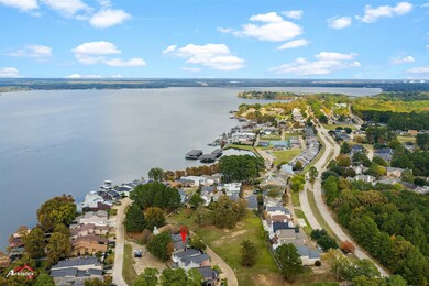 Aerial view of property's location featuring nearby suburban area and a large body of water