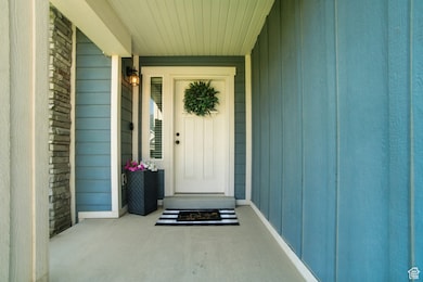 View of exterior entry featuring covered porch