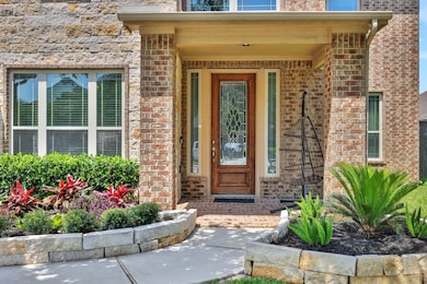 Welcoming front porch leads to a soaring two-story