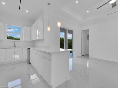 Kitchen featuring white cabinets, sink, stainless 