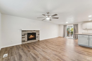 Unfurnished living room featuring a fireplace, light wood-type flooring, a ceiling fan, and recessed lighting