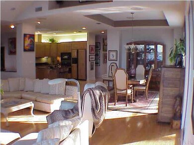 Entertaining doesn't get any better with the perfect day space this home offers. This view of the Dining room, Living room and Kitchen shows how easy it is for all to be in the moment. Custom lighting helps accents.