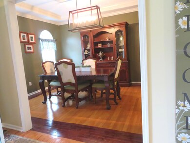 Formal dining room with beautiful hardwood flooring.