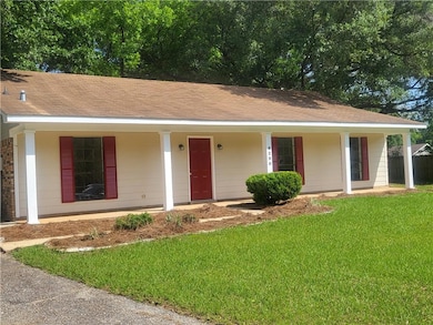 Ranch-style home featuring a porch and a front yard