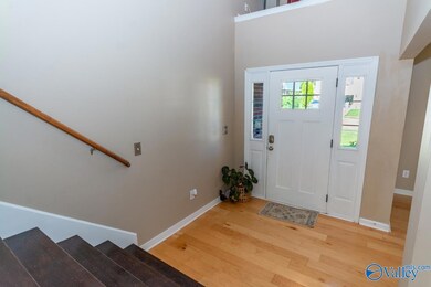 ENTER INTO THIS HOME THRU 7'X7' FOYER W/ SOARING CEILING AND HARDWOOD FLOORING.