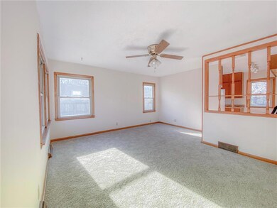 Main floor living room has large windows and ample