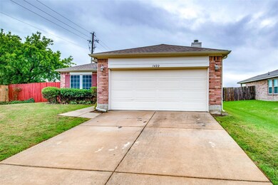 Ranch-style house with a garage and a front lawn