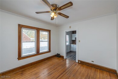 Dining room featuring ornamental molding, hardwood / wood-style flooring, and ceiling fan