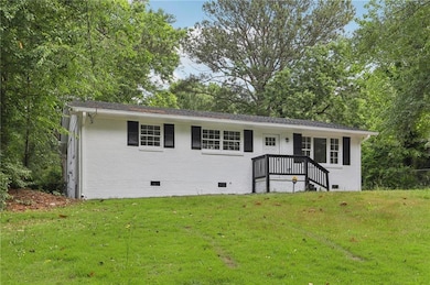 Ranch-style house featuring crawl space, a front yard, and brick siding